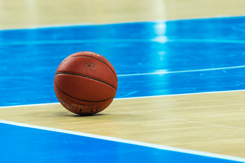 Basketball on the floor of the court.