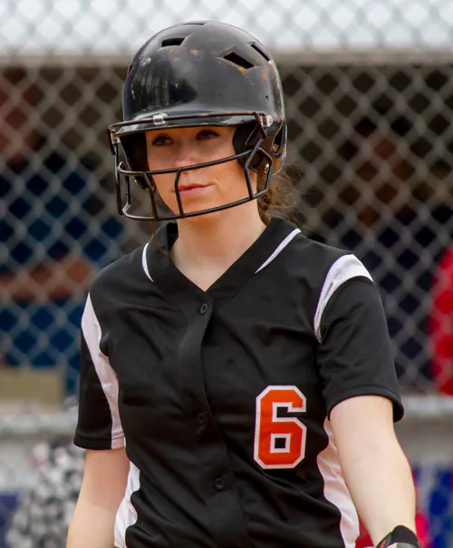 Softball player walking to bat